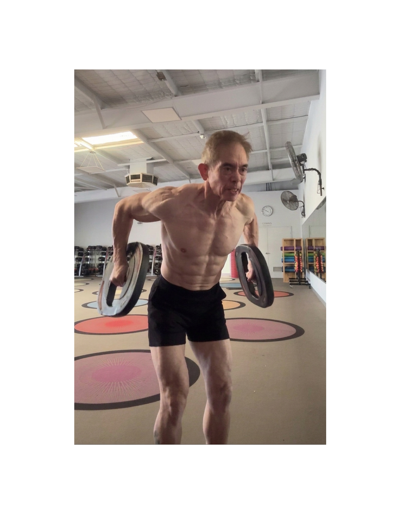 Calvin Cheok training with weight plates in the gym